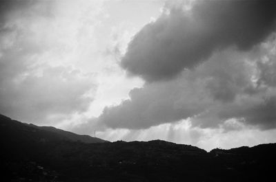 Low angle view of silhouette mountain against sky