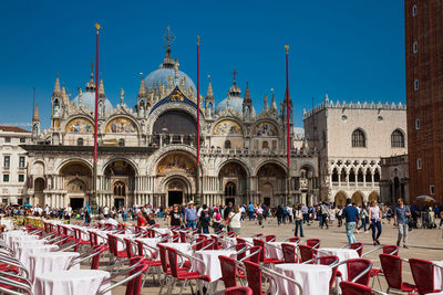 Restaurants and tourists at the famous saint mark square of venice in a beautiful early spring day