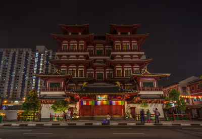 Low angle view of illuminated building against sky at night