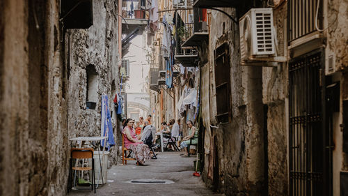 People on street amidst buildings in city