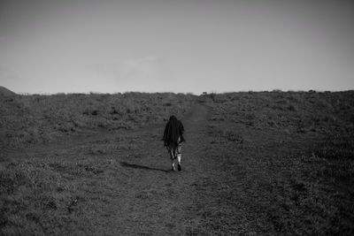 Full length of woman standing on landscape