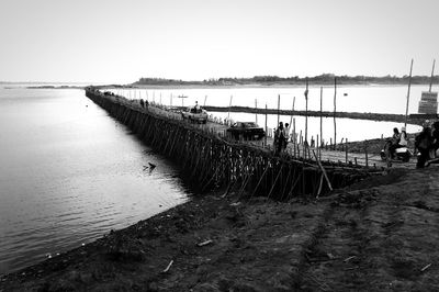 Pier on sea against clear sky
