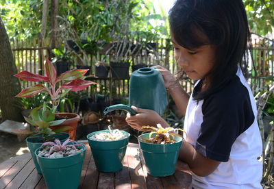 Cute girl watering plant