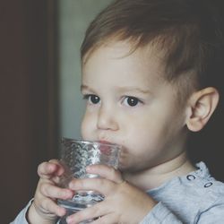 Close-up of cute baby boy drinking
