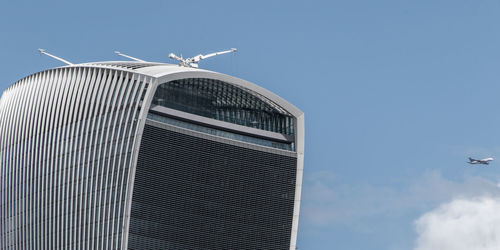 Low angle view of seagull flying in city