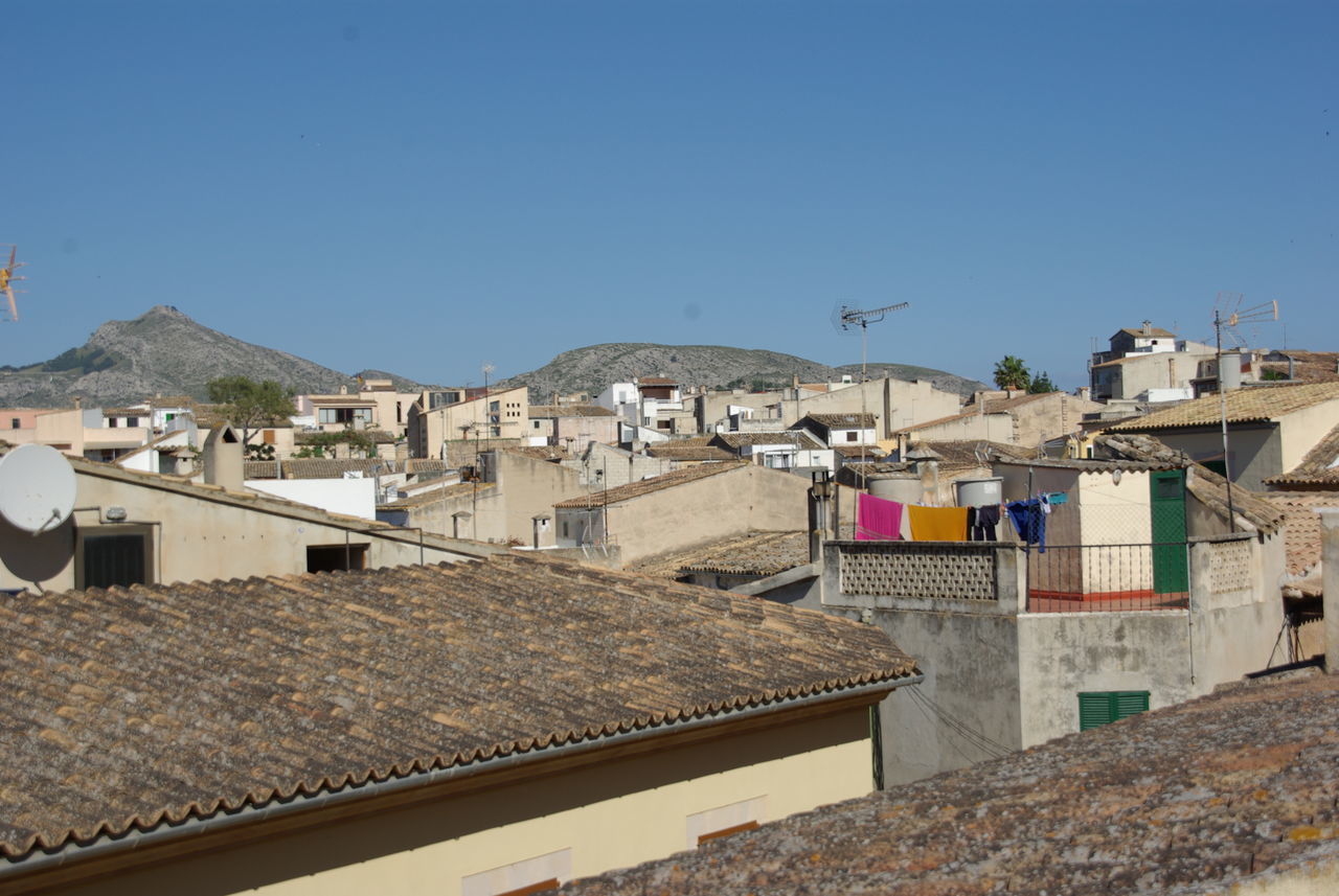 HOUSES AGAINST CLEAR BLUE SKY