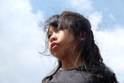 Low angle view of girl against sky