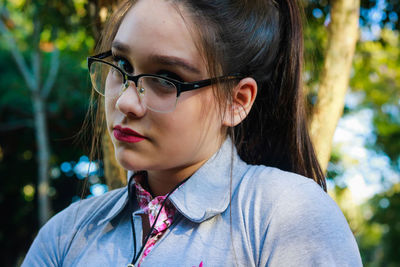 Portrait of young woman wearing eyeglasses at park