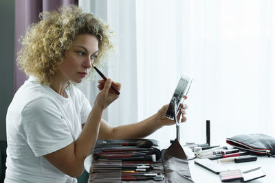 Portrait of young woman using phone