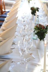 High angle view of wineglasses with tissues on dining table