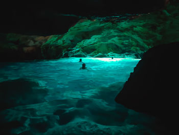 Silhouette of person swimming in sea