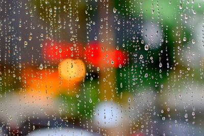 Full frame shot of wet glass window in rainy season