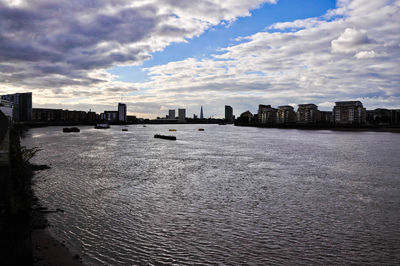 Cityscape against cloudy sky