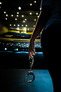 Midsection of woman holding illuminated lighting equipment