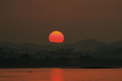 Scenic view of sea against orange sky