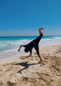  jump parkour on beach against clear sky