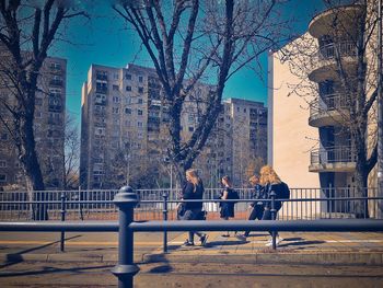 People in park against buildings in city