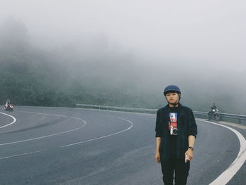 Full length of teenage girl standing on road