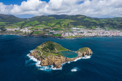 Scenic view of sea and buildings against sky