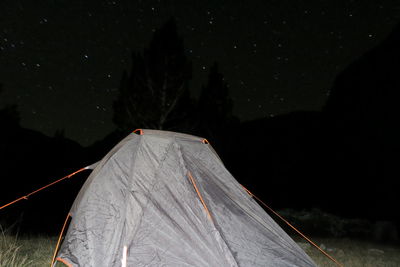 Tent on field against sky at night