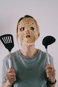 Midsection of woman holding pancake equipment