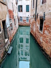 High angle view of canal amidst buildings in city