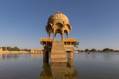 Gazebo in lake against sky