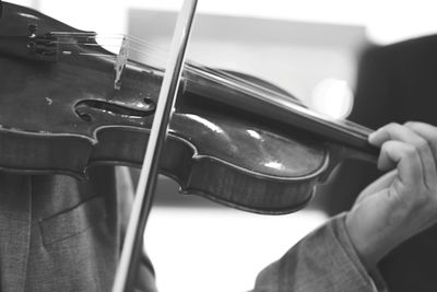 Close-up of man playing guitar