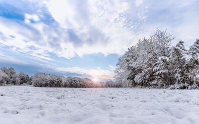 Snow covered field against sky