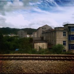 Buildings against cloudy sky