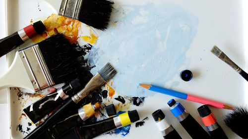 High angle view of paint brush on color palette, brush color with color palette,