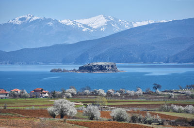 Scenic view of sea and mountains against sky