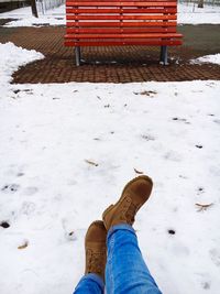 Low section of man standing on snow