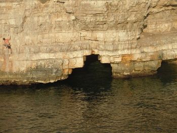 Scenic view of sea against rock formation