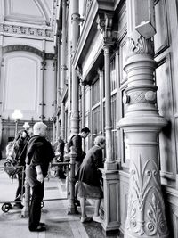 Rear view of people walking on building