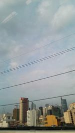 Low angle view of buildings against cloudy sky