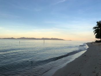 Scenic view of beach against sky during sunset