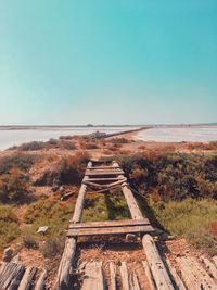 Scenic view of old landscape against clear blue sky