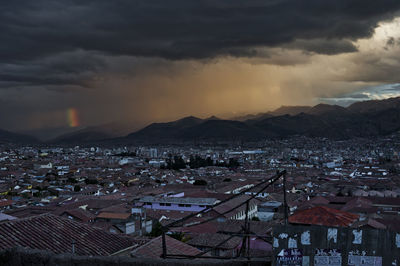 High angle view of houses in town against sky during sunset