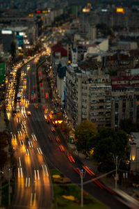 Illuminated city street and buildings at night