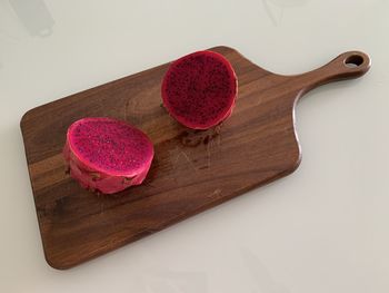 High angle view of dragonfruit on wooden board