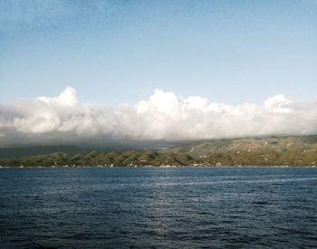 Scenic view of sea against cloudy sky