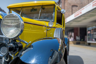 Close-up of vintage car in city