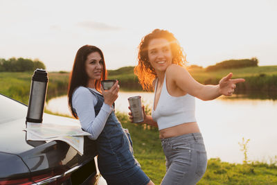 Portrait of smiling young woman using mobile phone