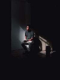 Rear view of man sitting on stage