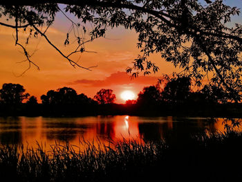 Scenic view of lake against romantic sky at sunset