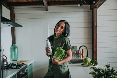 Full length of woman holding food at home