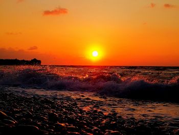 Scenic view of sea against orange sky