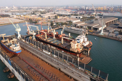 Shipyard and maintenance repair in sea and factory zonne background aerial view