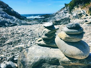 Close-up of rocks on beach against sky